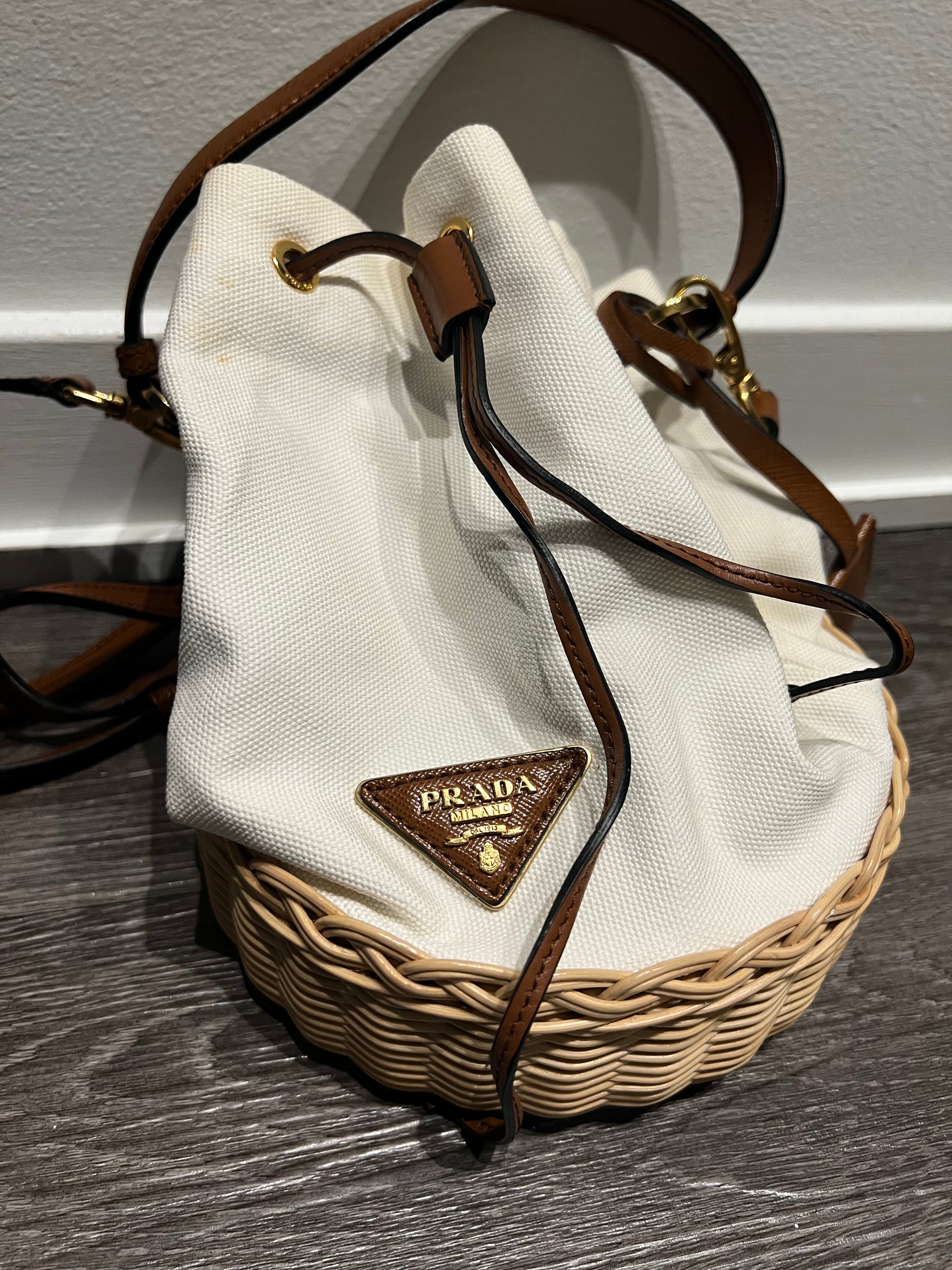 Prada small logo plaque wicker bucket bag Dimitria Chantel Co